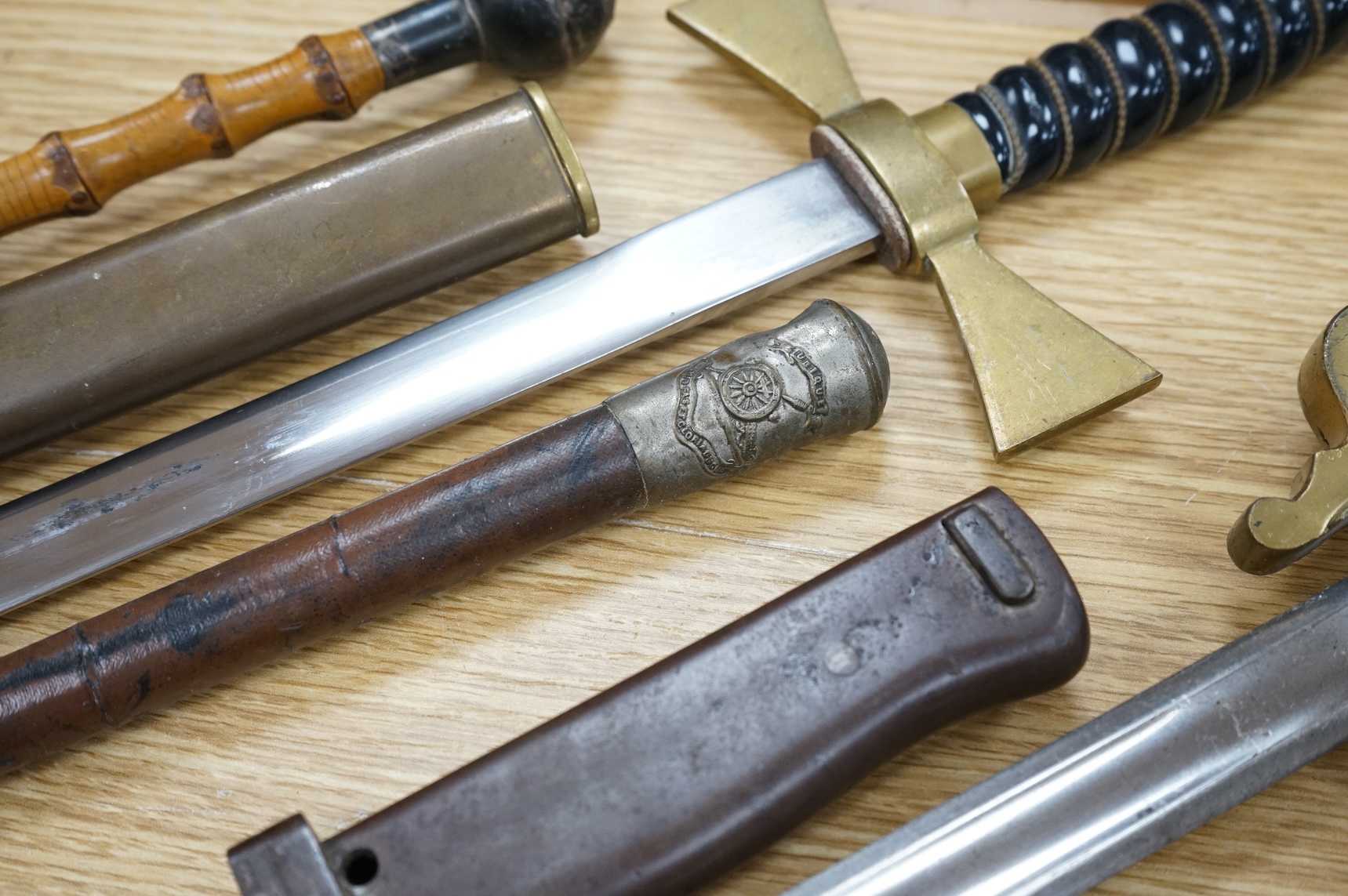 An Imperial German presentation infantry officer’s sword dated 1919/20, another similar with plain blade and brass stirrup hilt, another similar, plain in steel scabbard, a Wilkinson masonic sword probably circa 1950, a